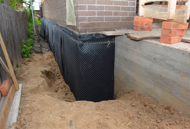 Happy homeowners after waterproofing job in Pratt